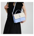 Detail of light blue and beige woven crossbody bag with golden round clasp and adjustable strap - Blue