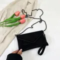 Elegant black rhinestone envelope clutch bag with dark grey chain strap and tulip accent - Black