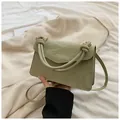 Sage green glossy leather small handbag with unique knotted double handles and shoulder strap - Green