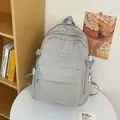 Minimalist light gray large capacity student backpack with fashion label on white table - Gray