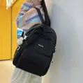 Minimalist black high-capacity school backpack with fashion label and white plush charm - Black
