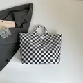 Glossy black and white checkerboard tote bag with TOTE BAG print in a modern style - Tote Bag / Black Checkerboard