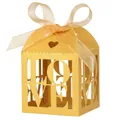 Close-up of golden paper wedding favor box with LOVE hollow-out design and ribbon bow - Gold