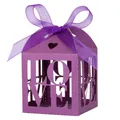 Close-up of purple laser-cut LOVE candy box with ribbon bow for wedding gifts - Deep purple