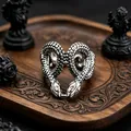 Macro shot of gothic double-headed snake ring with detailed scale texture on dark wood - J264 Twin Snakes