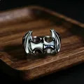 Macro view of silver bat-shaped superhero metal ring on a dark wooden display tray - J271 Silver Bat