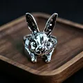 Detailed close-up of a vintage silver rabbit-shaped ring on a dark wooden tray - J276 Rabbit