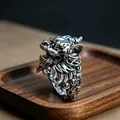 Detailed close-up of a vintage silver dragon ring with intricate scales on a wooden tray - J277 Leader