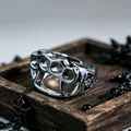 Detail showing vintage silver four-finger knuckle ring with gothic skull relief patterns - J278 Fist