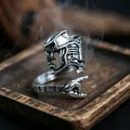 Macro shot of vintage silver skull ring with rock gesture design on dark wood - J285 Rap Guitar
