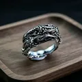 Macro shot of vintage metal ring with intricate organic textures on a wooden base - J315 Claw