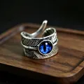 Macro detail of vintage silver feather ring featuring a blue evil eye stone inlay - J322 Blue Eyes
