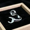 Close-up of adjustable silver wrench-shaped metal ring for men with industrial design - J329 Wrench