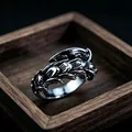 Macro shot of vintage silver metal ring featuring overlapping gothic feather design details - J331 Claw
