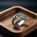 Retro silver metal dragon claw ring with detailed scale texture on a wooden tray - J161 Claw