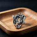 Retro gothic silver double snake ring featuring intricate scale textures on a wooden stand - J164 Twin Snakes