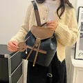 Chic quilted drawstring bucket backpack in black and brown contrast faux leather for women - Brown and Black