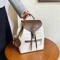 Cream and brown drawstring bucket backpack with quilted pattern and smiley charm - White