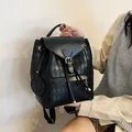 Quilted black drawstring bucket backpack with a smile charm and adjustable straps - Black