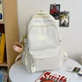 Minimalist cream white waterproof nylon backpack with cute plush charms for school - White With Brown Bear Charm
