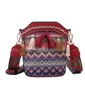 Bohemian woven bucket bag with vibrant geometric patterns and decorative red silk tassels - Red