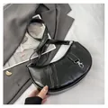 Detail of black crescent shoulder bag with vintage textured leather and silver clasp buckle - Black