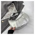 Detailed shot of silver crescent bag with metallic cracked texture and buckle detail - Silver