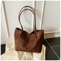 Detail of vintage dark brown tote bag showing premium suede texture and dual handles - Brown