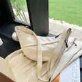 Minimalistische beige Nylon-Umhängetasche in Halbmondform mit verstellbarem Gurt - Cremeweiß