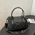 Large black textured tote bag with smooth flap, round handles and wide nylon shoulder strap - Black