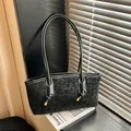 Chic black leopard print tote bag with knot details on a windowsill under sunlight - Black