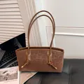 Chic brown leopard print suede shoulder bag with branding and decorative knot details - Coffee