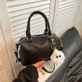 Black Boston bag in textured PU leather with white plush pendant and gold hardware - With Plush Charm / Black