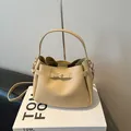 Elegante bolso de mano tipo cubo en cuero blanco crema con cierre giratorio dorado - Caqui