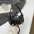 Glossy black mini bow shoulder bag with silver metallic accents and a sleek crescent shape - Black