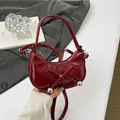 Mini burgundy crescent shoulder bag with bow detail and adjustable cross-body strap - Red