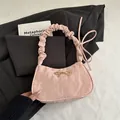 Pink pleated shoulder bag with golden metal bow and glossy finish for women - Pink