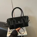 Minimalist black crossbody bag with white contrast stitching and silver hardware - Black