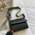 Black PU messenger bag with white stitching and ethnic patterned wide shoulder strap - Black