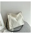 Minimalist cream corduroy tote bag with black faux leather straps and silver eyelets - White