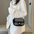 Elegante schwarze Strass-Vierecktasche mit Metallkette getragen von einem Model - Silber