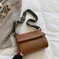 Brown vintage messenger bag with white stitching and colorful ethnic woven strap - Brown