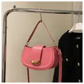 Pink saddle shoulder bag with golden crescent buckle and adjustable leather strap - Pink
