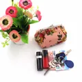Close-up of vintage pink floral canvas coin purse with silver metal kiss-lock closure - Pink