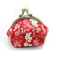 Detailed view of red Japanese cherry blossom fabric and retro metal kiss-lock closure - Red