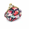 Close-up of Japanese cherry blossom floral fabric and engraved brass metal clasp frame - Dark Blue