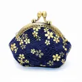 Close-up of Japanese pattern fabric coin purse with bronze clasp and gold cherry blossoms - Bronzing Blue