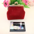 Detail of red linen coin purse with gold clasp, showing capacity next to lipstick and cards - Red