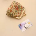 Handmade beige fabric coin purse with colorful floral patterns and gold metal clasp - Beige
