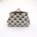 Detail of laser printed honey bee patterns on small PU leather coin purse with metal clasp - White